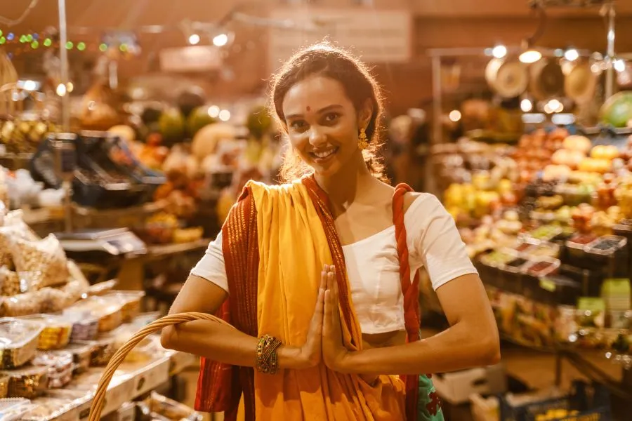 Indian woman at night market holding a basket